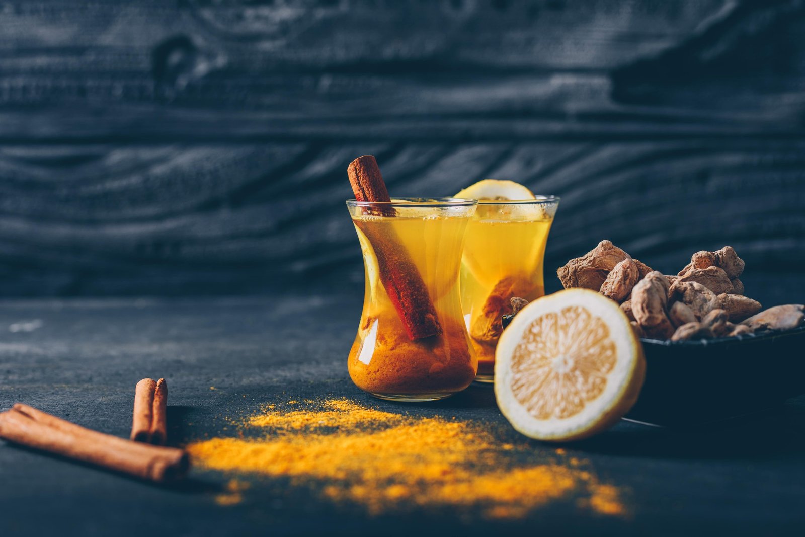 set lemon ginger dry cinnamon ginger powder tea cups dark textured background side view space text min scaled